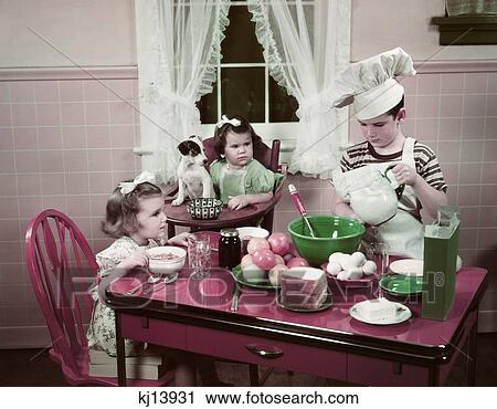 1940S 1950S Boy Two Girls At Kitchen Table Boy In Toque Cooking One Girl Eating Toddler And Puppy In High Chair View Large Photo Image Stock Image - 1940S 1950S Boy Two Girls At Kitchen Table Boy In Toque Cooking One Girl Eating Toddler And Puppy In High Chair . Fotosearch