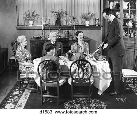 1940S Formal Dinner With Four Adults And Two Children One Man Standing At Head Of Table Carving The Turkey View Large Photo Image Stock Image - 1940S Formal Dinner With Four Adults And Two Children One Man Standing At Head Of Table Carving The Turkey . Fotosearch