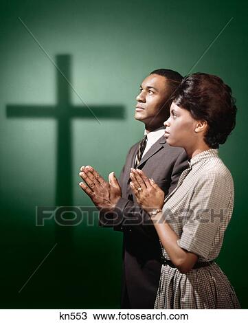 1950S 1960S African American Couple Man Woman Praying By Shadow Of Cross View Large Photo Image Stock Image - 1950S 1960S African American Couple Man Woman Praying By Shadow Of Cross . Fotosearch