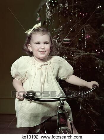 1950S Smiling Girl Riding Tricycle By Christmas Tree View Large Photo Image Stock Image - 1950S Smiling Girl Riding Tricycle By Christmas Tree . Fotosearch