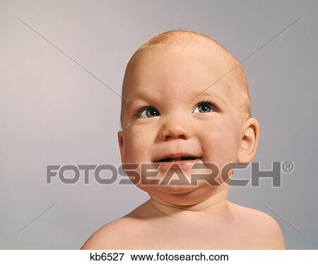 1960S 1970S Baby Portrait With Eyes Looking To Side With Sly Dubious Facial Expression View Large Photo Image Stock Photo - 1960S 1970S Baby Portrait With Eyes Looking To Side With Sly Dubious Facial Expression. Fotosearch