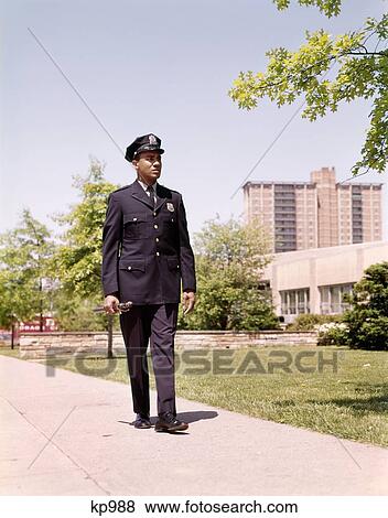1960S African American Policeman Officer Walking Sidewalk Neighborhood Beat View Large Photo Image Stock Photo - 1960S African American Policeman Officer Walking Sidewalk Neighborhood Beat . Fotosearch