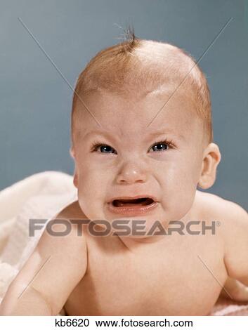 1960S Crying Baby With Angry Mean Facial Expression Looking At Camera View Large Photo Image Stock Image - 1960S Crying Baby With Angry Mean Facial Expression Looking At Camera. Fotosearch