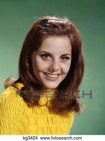 1960S Portrait Smiling Young Woman Long Brown Hair Yellow Shirt Looking At Camera View Large Photo Image Picture - 1960S Portrait Smiling Young Woman Long Brown Hair Yellow Shirt Looking At Camera. Fotosearch