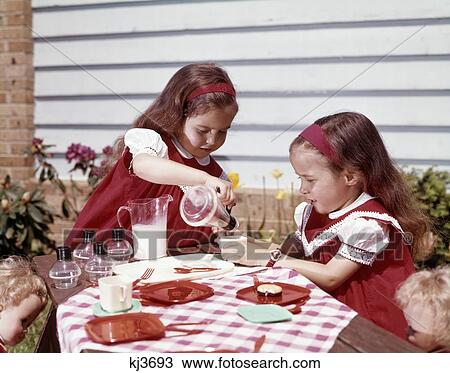 1960S Twin Girls Having A Tea Party Milk And Cookies View Large Photo Image Stock Image - 1960S Twin Girls Having A Tea Party Milk And Cookies . Fotosearch
