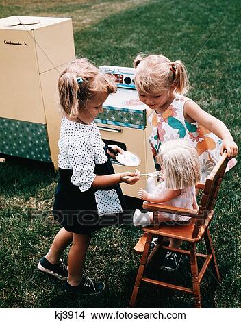 1960S Two Little Girls Playing Together Feeding Doll Toy Stove Refrigerator In Backyard View Large Photo Image Picture - 1960S Two Little Girls Playing Together Feeding Doll Toy Stove Refrigerator In Backyard . Fotosearch