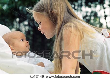 1970S Little Girl Looking At Baby View Large Photo Image Stock Photo - 1970S Little Girl Looking At Baby. Fotosearch