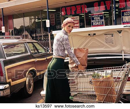 1970S Woman Putting Grocery Bags Into Trunk Of Car Looking At Camera View Large Photo Image Stock Photo - 1970S Woman Putting Grocery Bags Into Trunk Of Car Looking At Camera. Fotosearch
