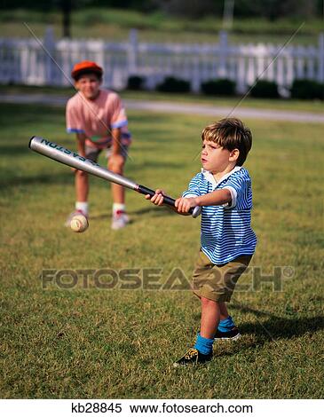 Stock Photography - 1980S 1990S Boy Swinging Baseball Bat. Fotosearch