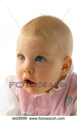 Stock Photo - 1990S Baby Blue Eyes In Pink Outfit With Blue Heart Looking Up. Fotosearch