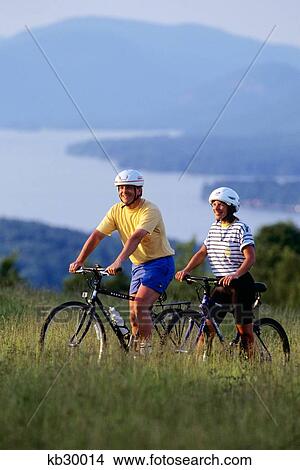 Couple Mountain Biking Adirondack Mountains Lake George, New York View Large Photo Image Picture - Couple Mountain Biking Adirondack Mountains Lake George, New York. Fotosearch