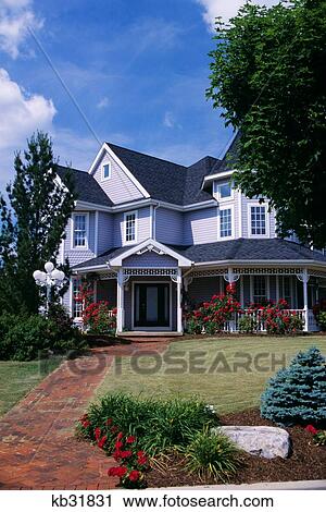 Stock Image - House With Porch Rose Trellis And Brick Walk. Fotosearch