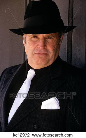 Stock Image - Man In Black Suit And Fedora. Fotosearch