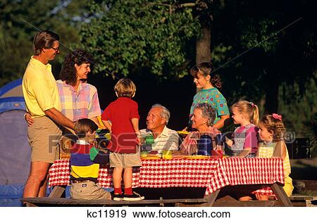Three Generation Family At Picnic Table Campsite With Tent View Large Photo Image Stock Photo - Three Generation Family At Picnic Table Campsite With Tent. Fotosearch