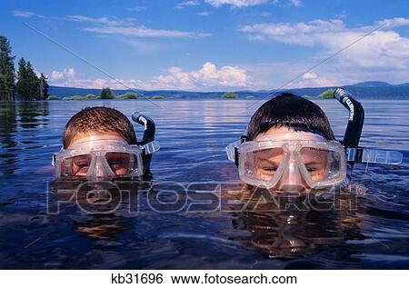 Two Boys Snorkeling In Mountain Lake Peering Over Water Looking At Camera View Large Photo Image Stock Photograph - Two Boys Snorkeling In Mountain Lake Peering Over Water Looking At Camera. Fotosearch