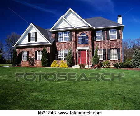 Two-Story Brick House With Landscaped Lawn And Red Front Door View Large Photo Image Stock Photo - Two-Story Brick House With Landscaped Lawn And Red Front Door. Fotosearch