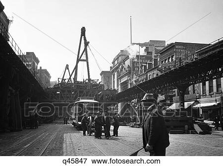 1918 Construction Crane & Crew Making Improvements To The Third Avenue Elevated Train In The Bowery Lower Manhattan New York Usa View Large Photo Image Stock Photo - 1918 Construction Crane & Crew Making Improvements To The Third Avenue Elevated Train In The Bowery Lower Manhattan New York Usa. Fotosearch