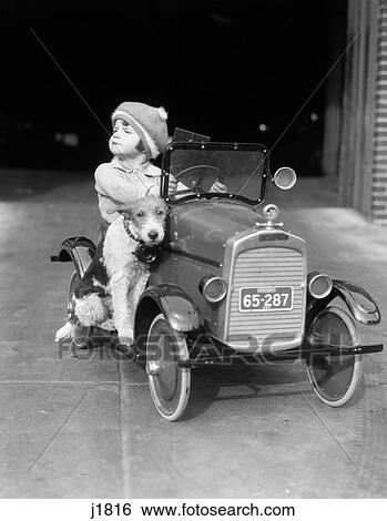 1920S Girl In Toy Pedal Car With Dog Sitting On Running Board Girl Looking To Side Head Up  View Large Photo Image Stock Photograph - 1920S Girl In Toy Pedal Car With Dog Sitting On Running Board Girl Looking To Side Head Up . Fotosearch