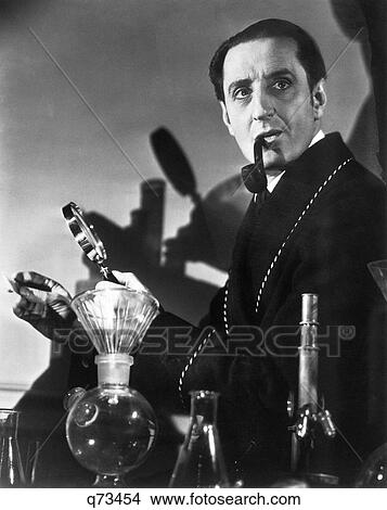 Picture - 1930S 1940S Basil Rathbone Actor As Consulting Detective Sherlock Holmes With Pipe Magnifying Glass By Author Arthur Conan Doyle. Fotosearch