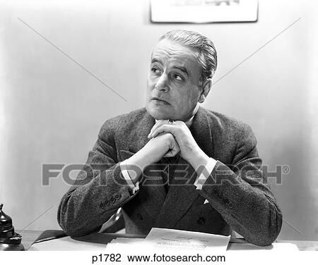 1930S 1940S Man Portrait At Desk Businessman Wearing Suit Hands Clasped Under Chin Looking Off To Side View Large Photo Image Stock Image - 1930S 1940S Man Portrait At Desk Businessman Wearing Suit Hands Clasped Under Chin Looking Off To Side . Fotosearch