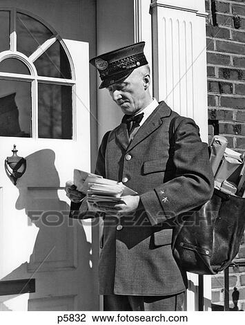 1930S 1940S Postal Service Uniformed Mailman Delivering Mail Standing On Doorstep Sorting Letters View Large Photo Image Stock Image - 1930S 1940S Postal Service Uniformed Mailman Delivering Mail Standing On Doorstep Sorting Letters. Fotosearch
