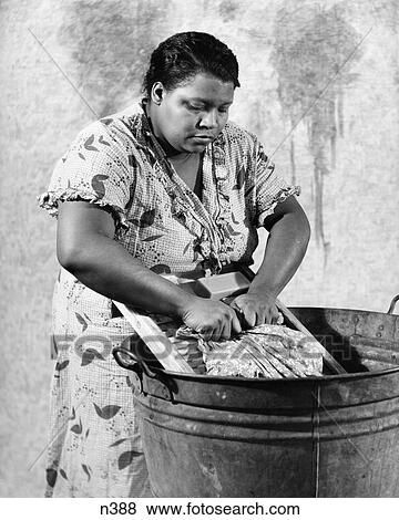 1930S African-American Woman Washing Scrubbing Clothes On Washboard In A Galvanized Zinc Washtub View Large Photo Image Stock Photo - 1930S African-American Woman Washing Scrubbing Clothes On Washboard In A Galvanized Zinc Washtub . Fotosearch