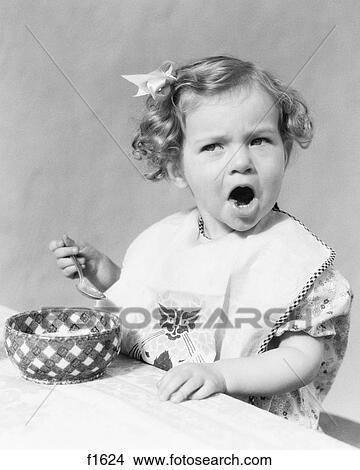 1930S Girl Eating In Highchair Making Funny Face Mouth Open View Large Photo Image Picture - 1930S Girl Eating In Highchair Making Funny Face Mouth Open. Fotosearch