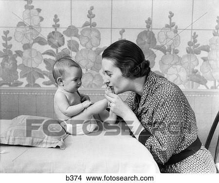 1930S Woman Mother Kissing Babys Feet View Large Photo Image Picture - 1930S Woman Mother Kissing Babys Feet. Fotosearch
