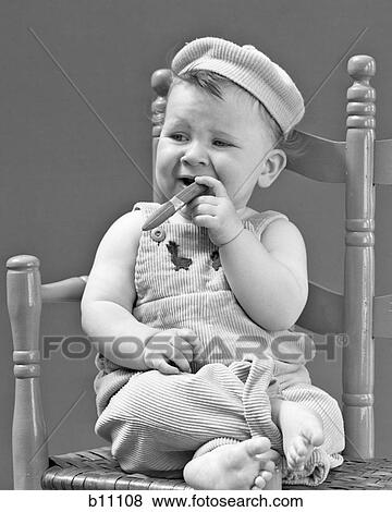 1940S 1950S Baby Sitting Chair Holding Cigar Looking Very Gangster View Large Photo Image Stock Photo - 1940S 1950S Baby Sitting Chair Holding Cigar Looking Very Gangster. Fotosearch
