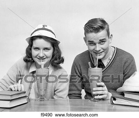 1940S Teenage Boy And Girl Drinking Milkshakes Together Looking At Camera View Large Photo Image Stock Image - 1940S Teenage Boy And Girl Drinking Milkshakes Together Looking At Camera. Fotosearch