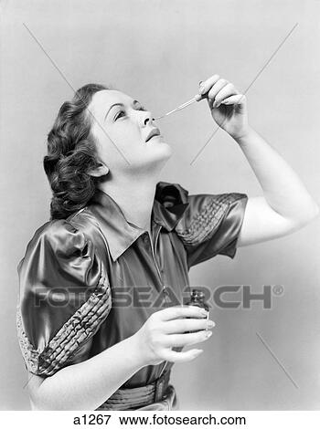 1940S Woman Head Tilted Back Using Glass Eye Or Nose Dropper View Large Photo Image Stock Photo - 1940S Woman Head Tilted Back Using Glass Eye Or Nose Dropper . Fotosearch