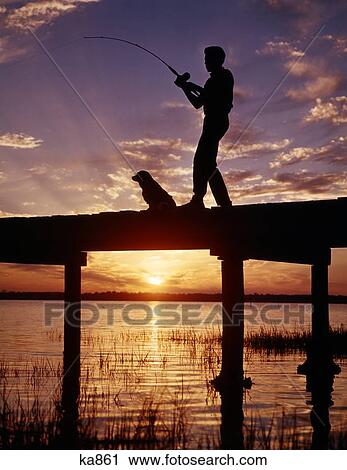 1950S 1960S Anonymous Silhouetted Boy Fishing With His Dog On Dock At Sunset Or Sunrise View Large Photo Image Stock Image - 1950S 1960S Anonymous Silhouetted Boy Fishing With His Dog On Dock At Sunset Or Sunrise. Fotosearch