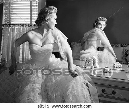 1950S Blonde In Strapless Gown With Crinolines Turning To Look At Back View Of Self In Mirror View Large Photo Image Stock Photography - 1950S Blonde In Strapless Gown With Crinolines Turning To Look At Back View Of Self In Mirror. Fotosearch