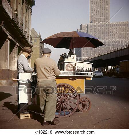 1950S Man Hot Dog Vendor Pushcart With Umbrella Selling Cokes For 15 Cents West Street Downtown Manhattan New York Usa View Large Photo Image Stock Photo - 1950S Man Hot Dog Vendor Pushcart With Umbrella Selling Cokes For 15 Cents West Street Downtown Manhattan New York Usa . Fotosearch