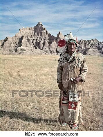 1950S Portrait Sioux Indian Man Standing In Badlands Of South Dakota Wearing Native American Dress Looking At Camera View Large Photo Image Stock Photography - 1950S Portrait Sioux Indian Man Standing In Badlands Of South Dakota Wearing Native American Dress Looking At Camera. Fotosearch