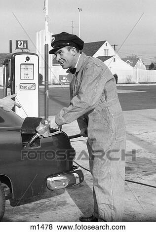 1950S Service Station Attendant Man In Striped Overalls & Cap Filling Gas Tank Of Automobile View Large Photo Image Stock Photo - 1950S Service Station Attendant Man In Striped Overalls & Cap Filling Gas Tank Of Automobile. Fotosearch