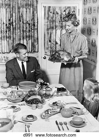 1950S Thanksgiving Family At Dining Room Table Mom Holding Turkey On Platter Print Curtains Table Setting Wallpaper View Large Photo Image Stock Image - 1950S Thanksgiving Family At Dining Room Table Mom Holding Turkey On Platter Print Curtains Table Setting Wallpaper. Fotosearch