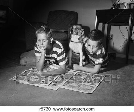 1950S Two Boys Reading Sunday Comics Living Room Floor Dog Indoor Funny Papers Newspapers View Large Photo Image Stock Image - 1950S Two Boys Reading Sunday Comics Living Room Floor Dog Indoor Funny Papers Newspapers. Fotosearch