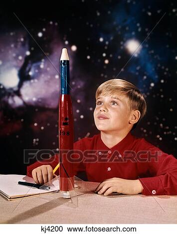 1960S Boy With Model Rocket Daydreaming Looking At Rocket On Desk Star Galaxy Background View Large Photo Image Stock Image - 1960S Boy With Model Rocket Daydreaming Looking At Rocket On Desk Star Galaxy Background. Fotosearch
