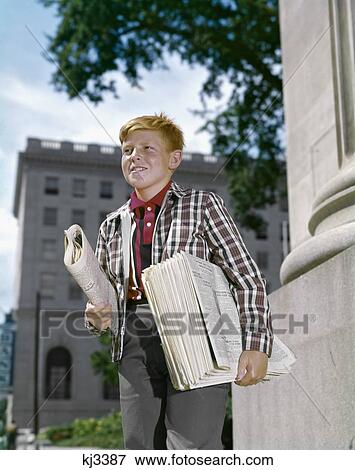 1960S Smiling Boy Red Hair Wearing Plaid Jacket Selling Newspapers On Sidewalk View Large Photo Image Stock Photo - 1960S Smiling Boy Red Hair Wearing Plaid Jacket Selling Newspapers On Sidewalk. Fotosearch