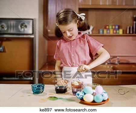 1960S Smiling Girl Wearing Pink Blouse Dyeing Easter Eggs In Kitchen View Large Photo Image Stock Photo - 1960S Smiling Girl Wearing Pink Blouse Dyeing Easter Eggs In Kitchen. Fotosearch