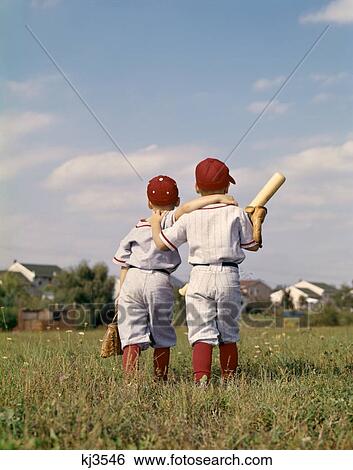 1960S Two Boys Brothers Teammates Wearing Little League Baseball Uniforms Walking Arm In Arm Away From Camera View Large Photo Image Stock Photograph - 1960S Two Boys Brothers Teammates Wearing Little League Baseball Uniforms Walking Arm In Arm Away From Camera. Fotosearch