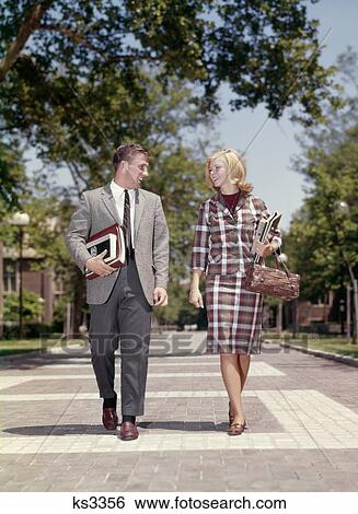 1960S Young Adult Man Woman Walking Side By Side On College Campus Smiling Happy View Large Photo Image Stock Photograph - 1960S Young Adult Man Woman Walking Side By Side On College Campus Smiling Happy . Fotosearch