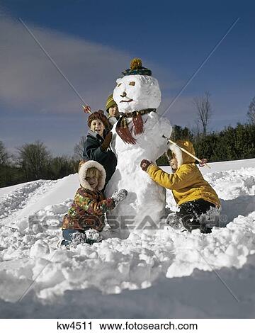 1970S Four Children Making A Snowman View Large Photo Image Stock Image - 1970S Four Children Making A Snowman. Fotosearch