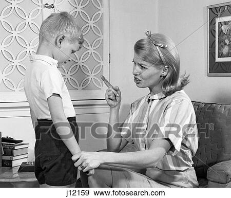 1970S Mother Disciplining Her Son By Talking Harshly And Shaking Her Finger Boy Hanging His Head In Shame View Large Photo Image Stock Photo - 1970S Mother Disciplining Her Son By Talking Harshly And Shaking Her Finger Boy Hanging His Head In Shame. Fotosearch