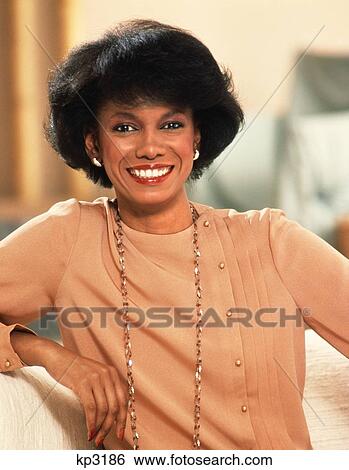 1980S Portrait Of Smiling Well Dressed Confident African American Woman Looking At Camera View Large Photo Image Stock Photograph - 1980S Portrait Of Smiling Well Dressed Confident African American Woman Looking At Camera. Fotosearch