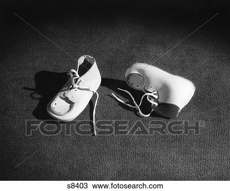 Pair Of Baby Booties In Spotlight One Upright & One On Side View Large Photo Image Stock Image - Pair Of Baby Booties In Spotlight One Upright & One On Side. Fotosearch