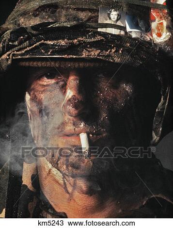 Portrait 1970S Soldier Smoking Cigarette Camouflage Uniform And Paint On Face Picture Of Woman In Headband View Large Photo Image Stock Image - Portrait 1970S Soldier Smoking Cigarette Camouflage Uniform And Paint On Face Picture Of Woman In Headband. Fotosearch