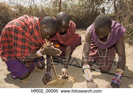 Stock Photography - Three Masai Men Making Fire. Fotosearch