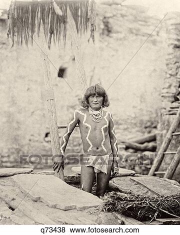 Stock Photo - 1800s 1890s 1897 HOPI INDIAN MAN LOOKING AT CAMERA DESCENDING INTO ANTELOPE KIVA WALPI PUEBLO. Fotosearch